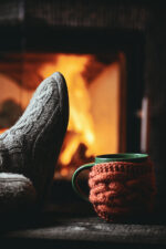 Person sitting by fireplace