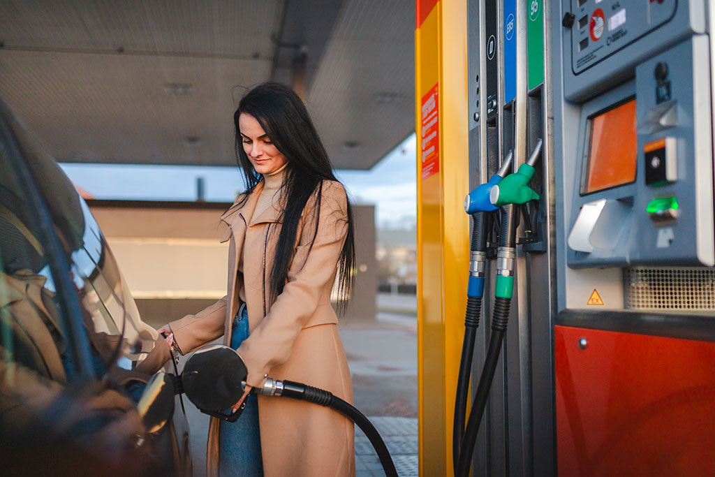 Woman putting gas in car
