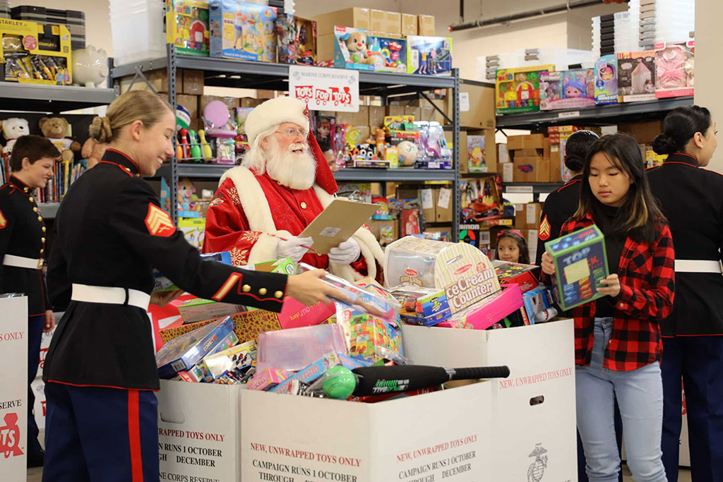 Passing out toys to kids at Toys for Tots events