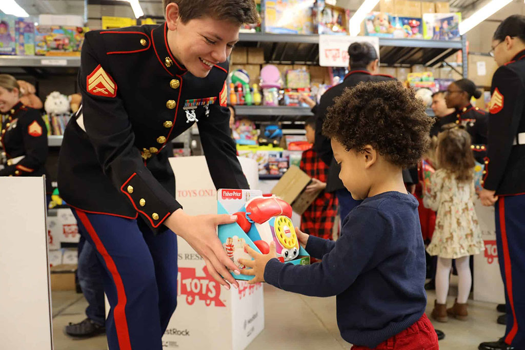 Passing out toys to kids at Toys for Tots events